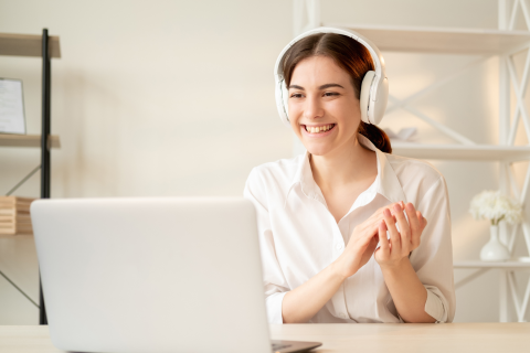 Image of woman smiling at laptop